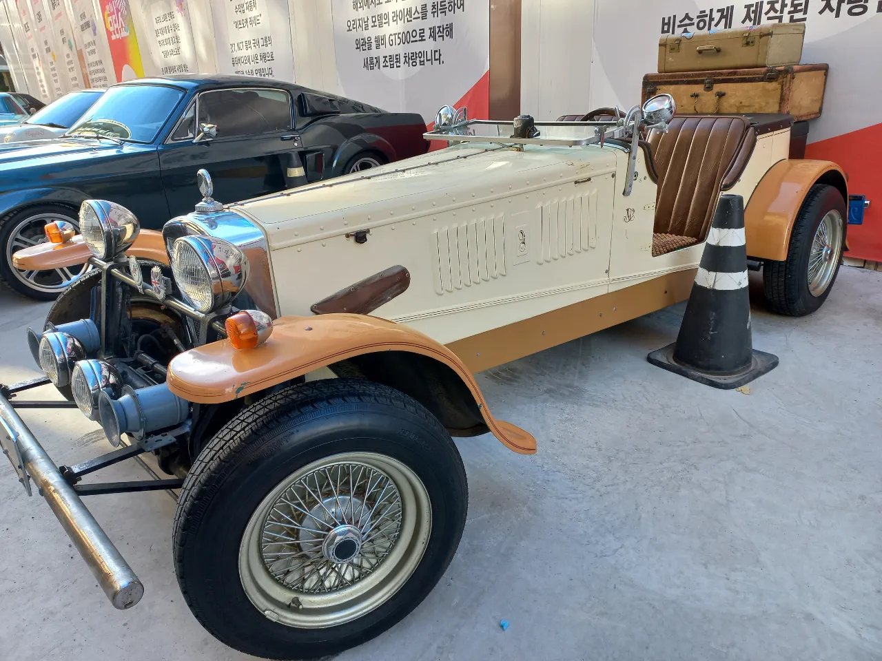 an old fashioned car is parked in a parking lot