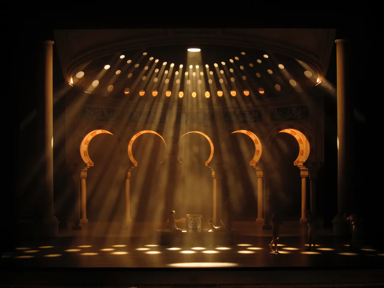 a stage with a spotlight coming from the ceiling