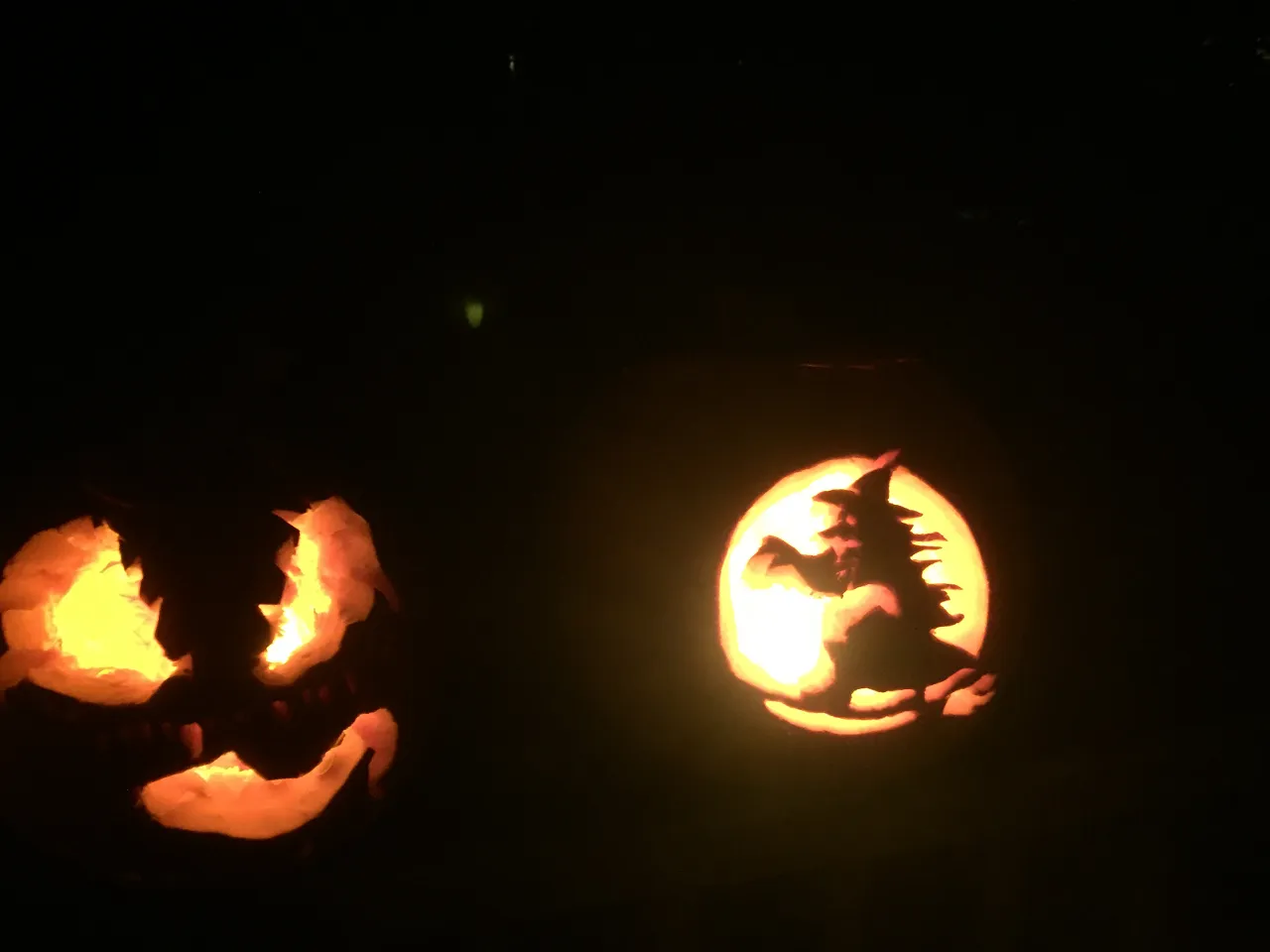 a couple of jack-o-lanterns sitting on top of a table