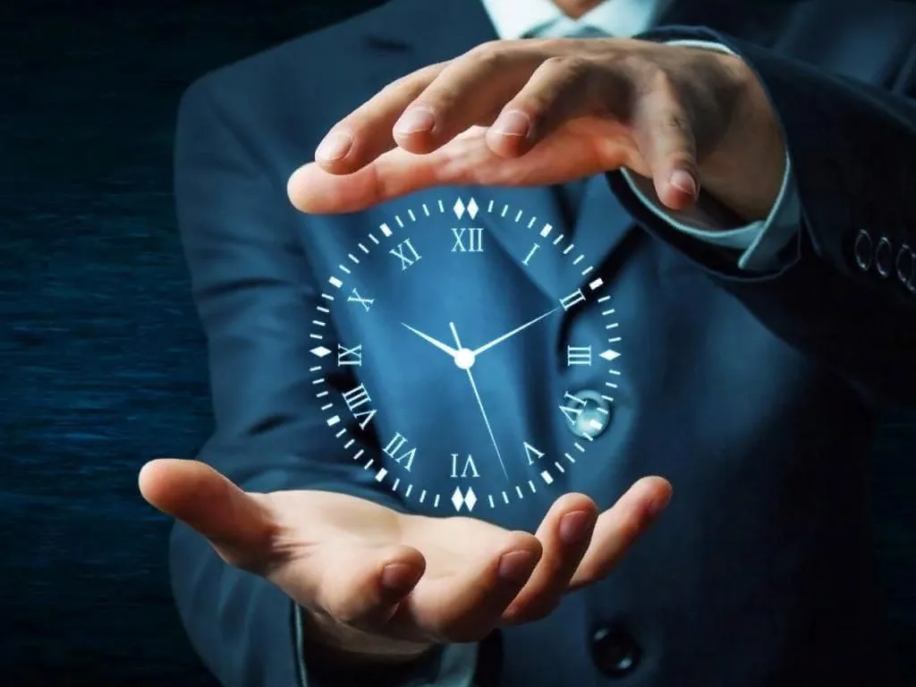 a man in a suit holding a clock in his hands