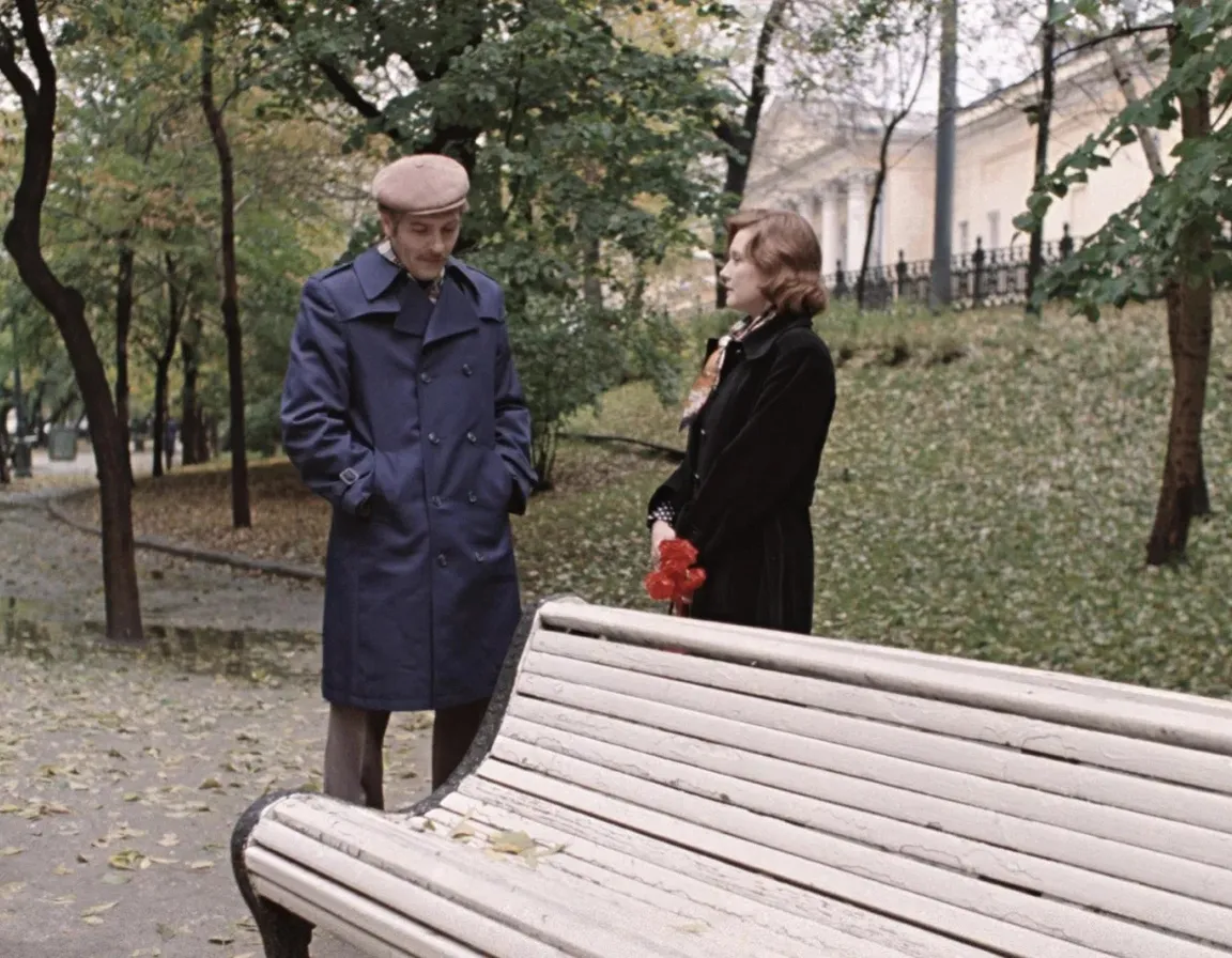 a man and a woman standing next to a wooden bench