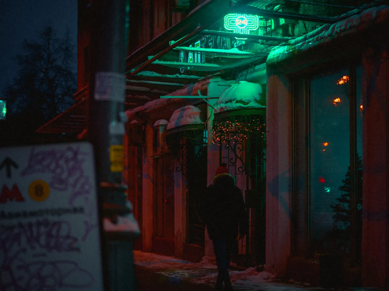 a person walking down a street at night