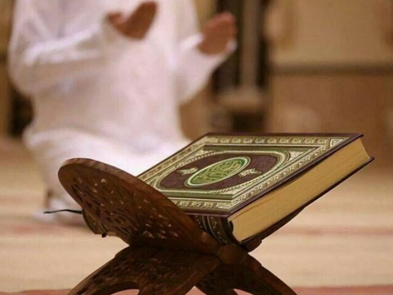 a book koran sitting on top of a wooden stand