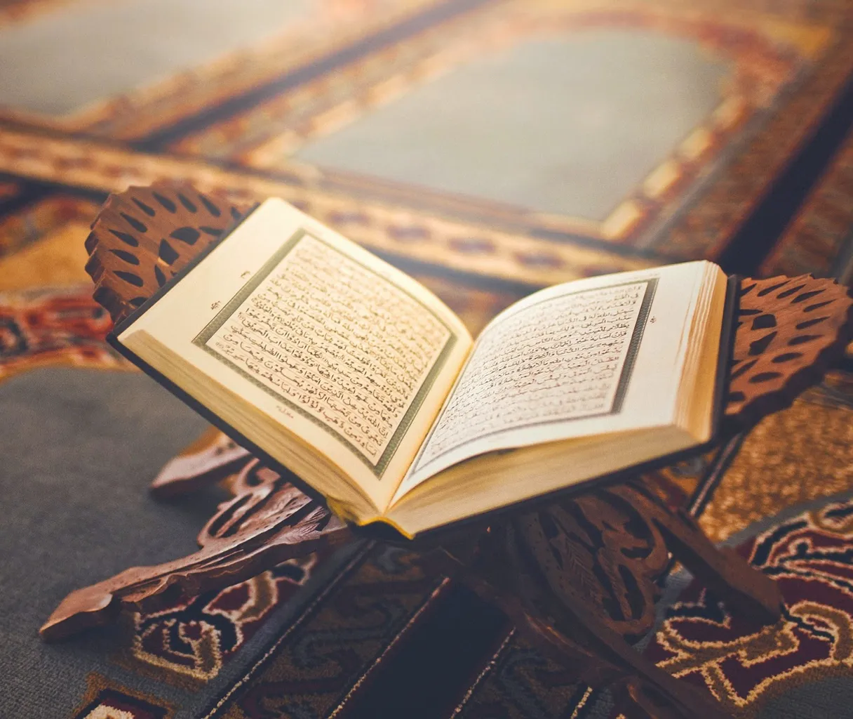 an open book sitting on top of a wooden table