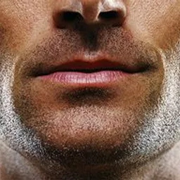 a close up of a man's face and neck