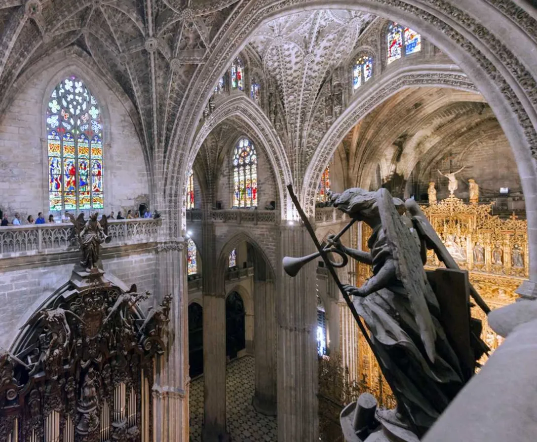 a statue of a woman holding a sword in a cathedral