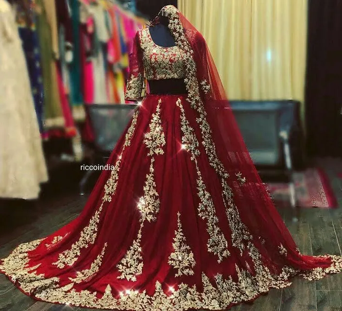 a red and gold bridal gown on a mannequin