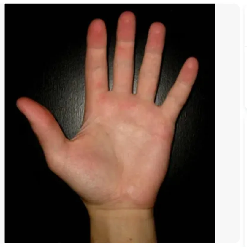 a person's hand with a black background