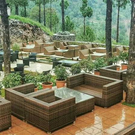 a group of brown wicker couches and tables