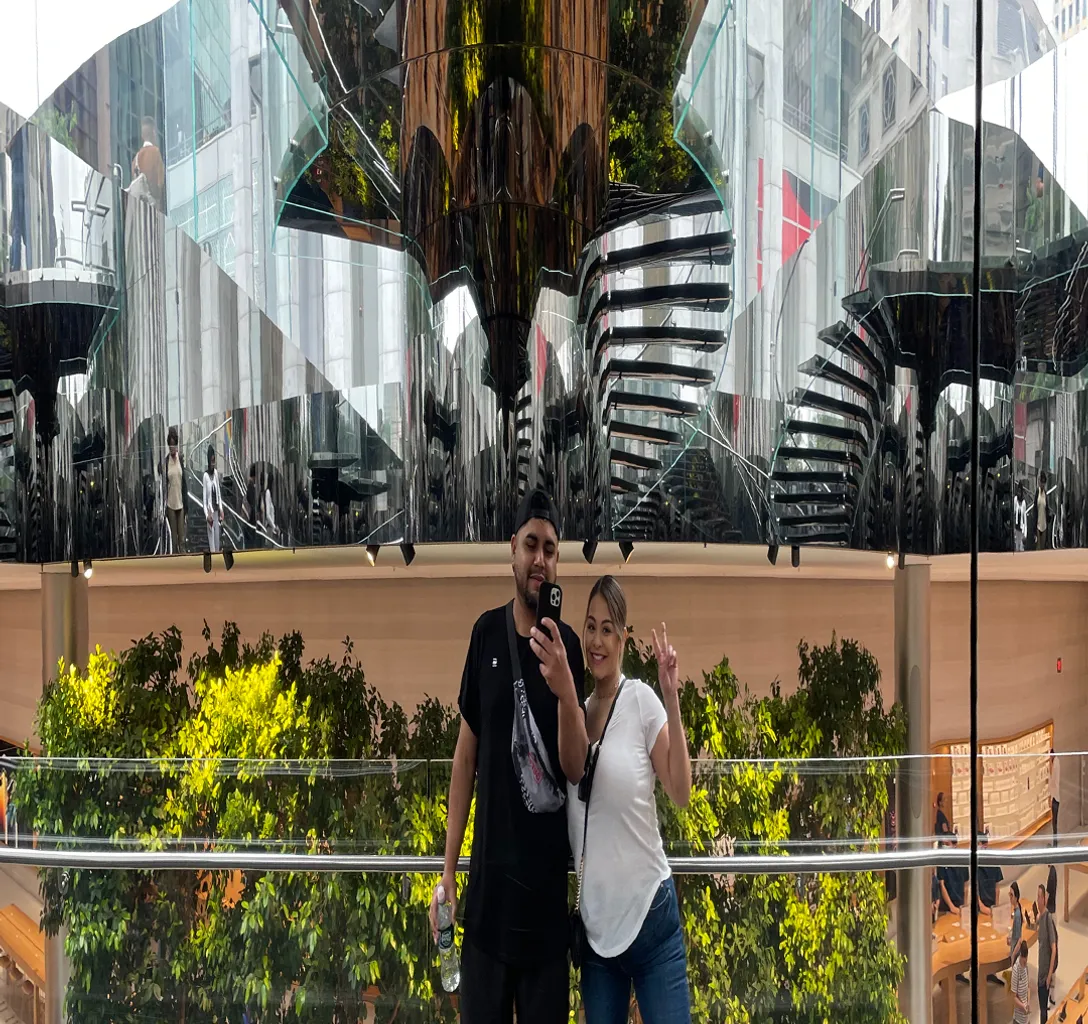 a man and a woman standing next to each other going down a trippy mirror multiverse