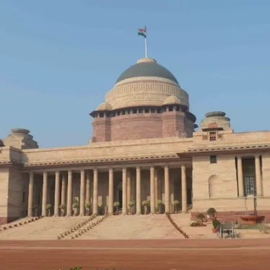 Rashtrapati bhavan a large building with a Indian flag on top of it 