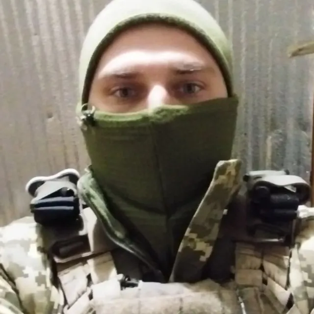 a man in a camouflage outfit with a hood on