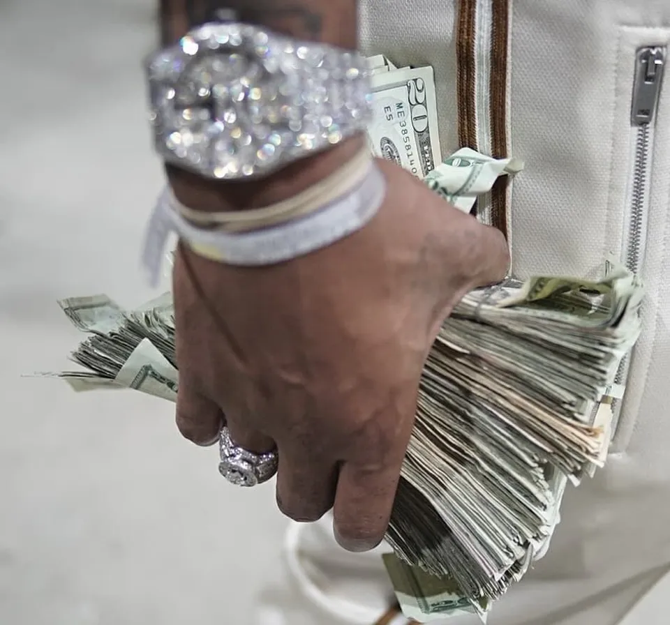 a person holding a bag full of money