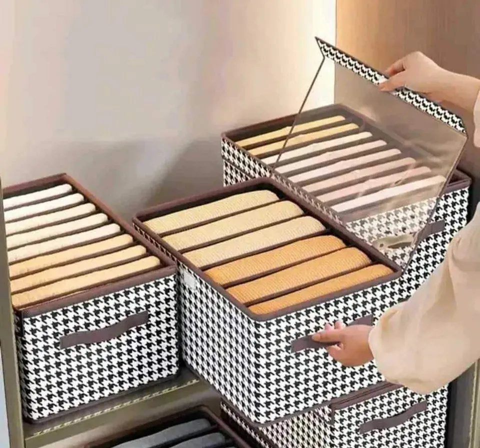 a woman is putting a tray of bread into a drawer