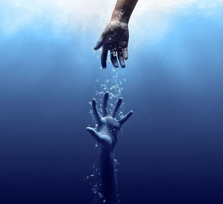 two hands reaching for each other in the water