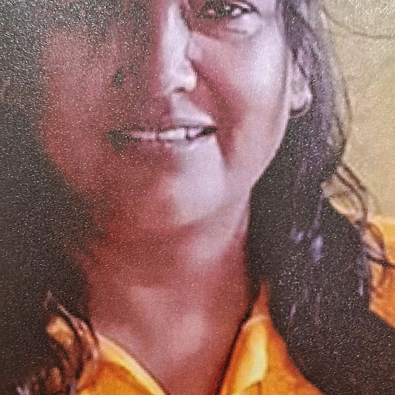 a close up of a person wearing a yellow shirt