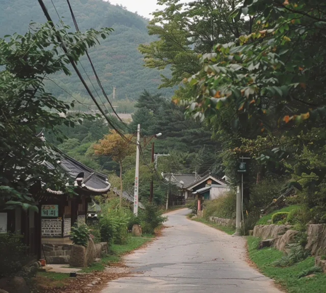 an empty street with a mountain in the background