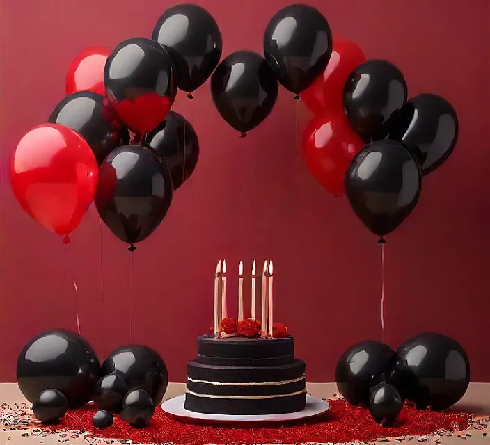 a birthday cake surrounded by black and red balloons