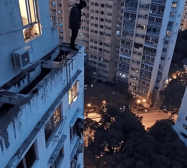 a man standing on top of a tall building