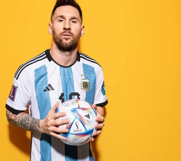 Messi  holding a soccer ball in his hands