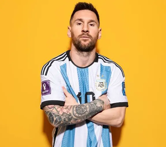 Messi  standing in front of a yellow background