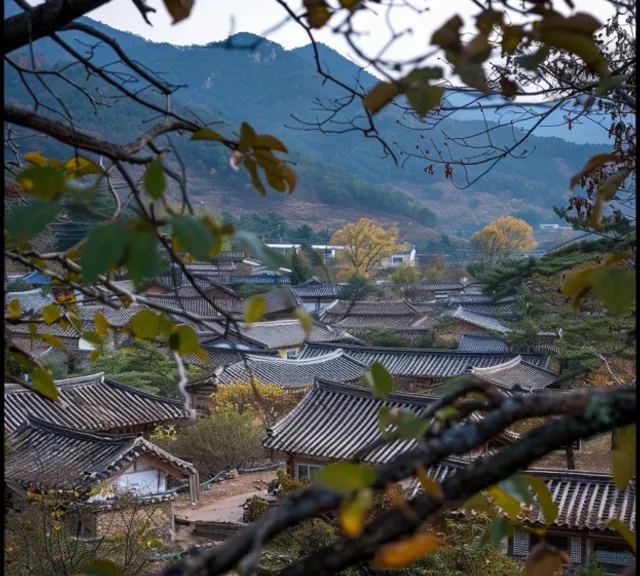 a view of a village with mountains in the background