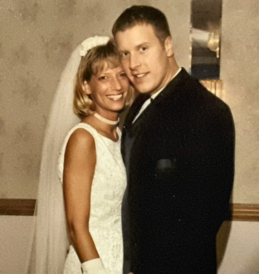 a bride and groom posing for a picture then kissing each other