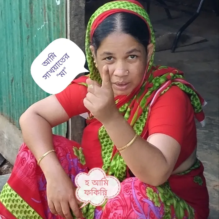 a woman sitting on the ground holding a sign