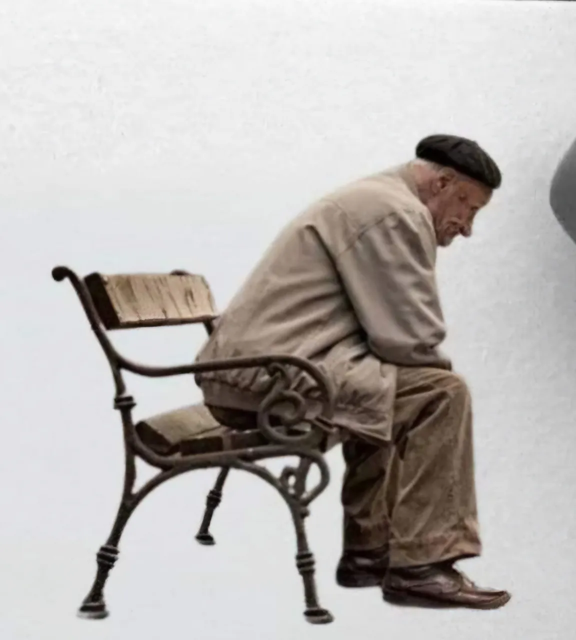 a man sitting on a bench next to a wall