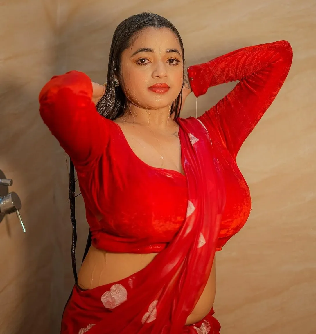 a woman in a red sari posing for a picture