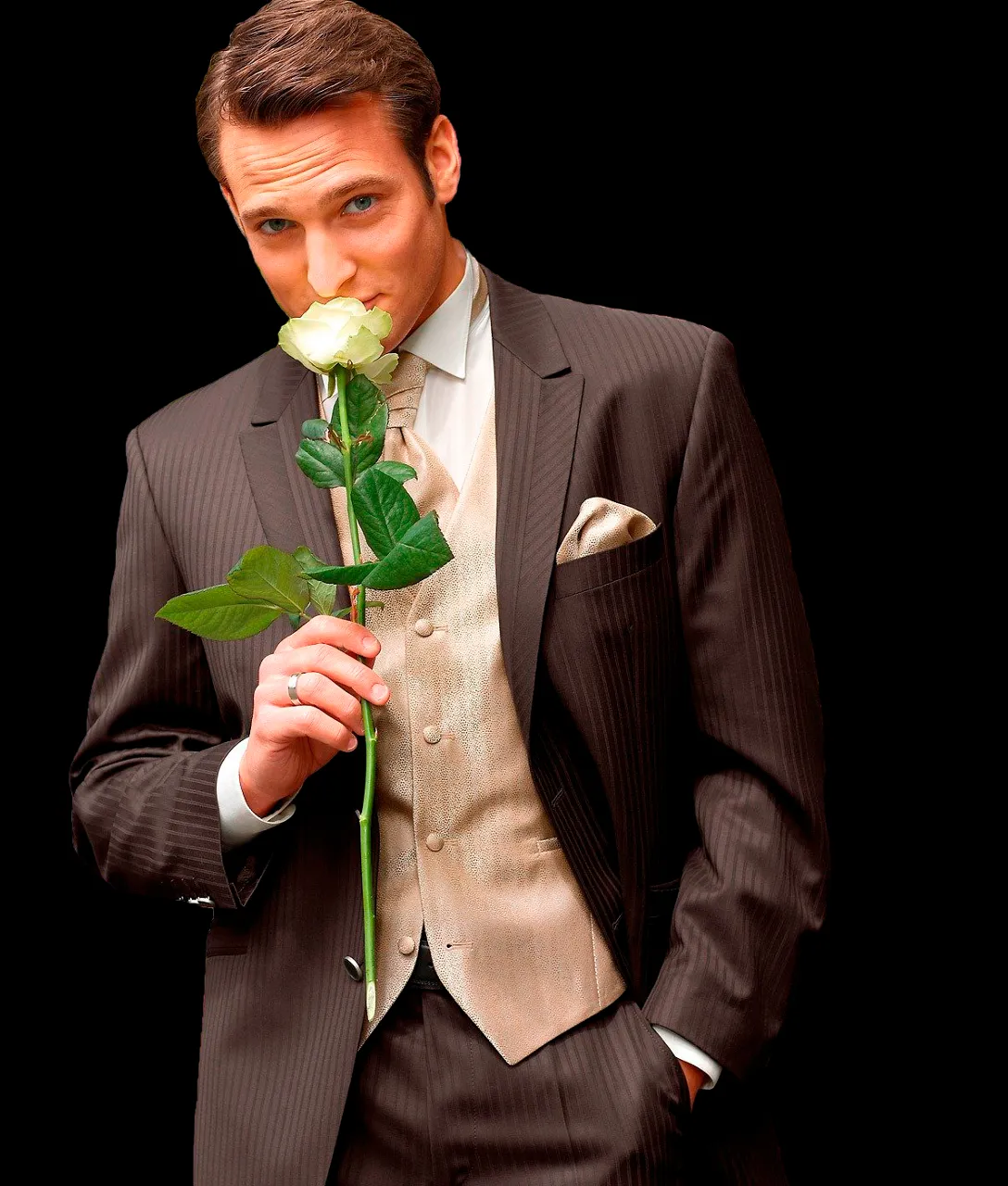 a man in a suit holding a rose in his hand