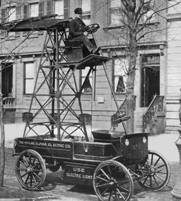 an old photo of a man sitting on top of a fire hydrant