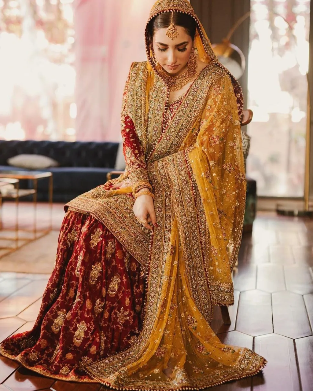 a woman in a yellow and red bridal outfit