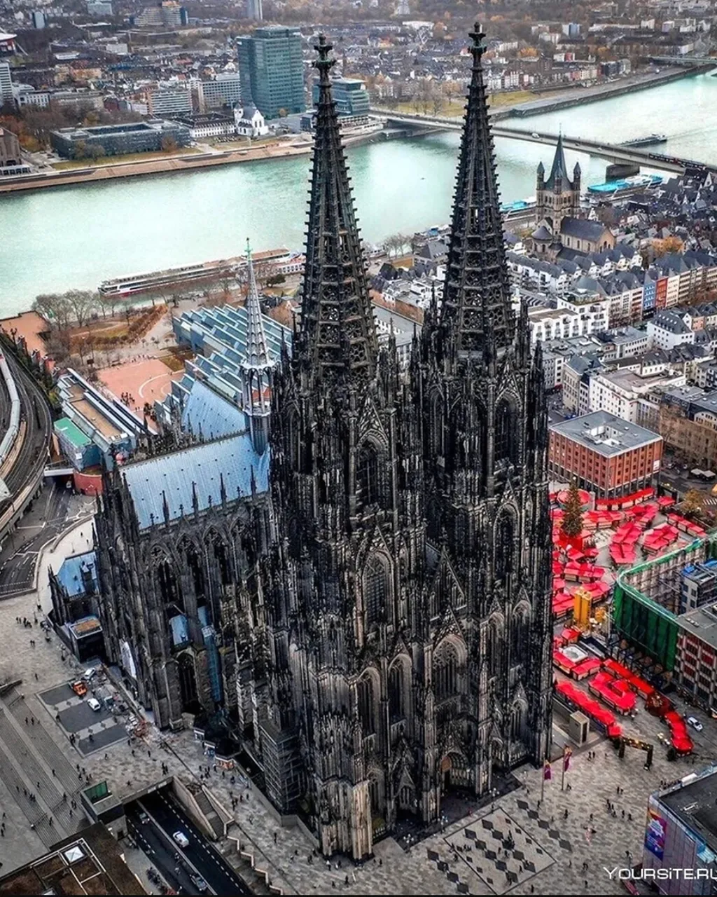 an aerial view of a large cathedral in a city