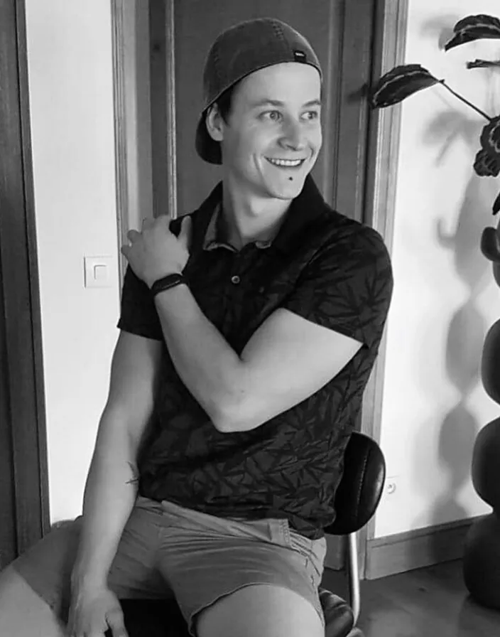 a black and white photo of a man sitting in a chair