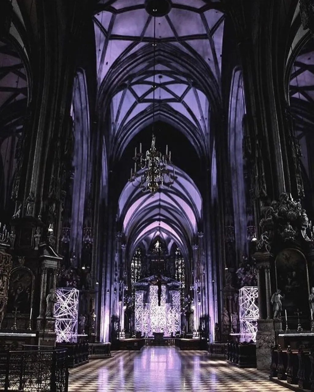 a large cathedral with a checkered floor and chandelier