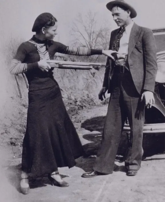 a man and a woman standing next to a car