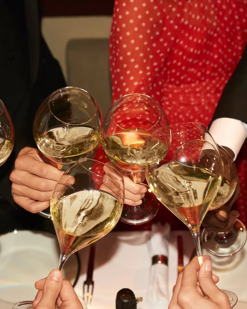 a group of people holding up wine glasses