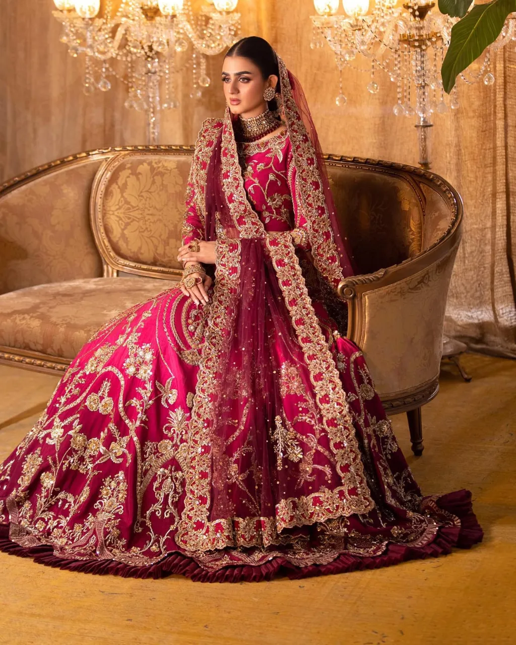 a woman in a red and gold wedding dress