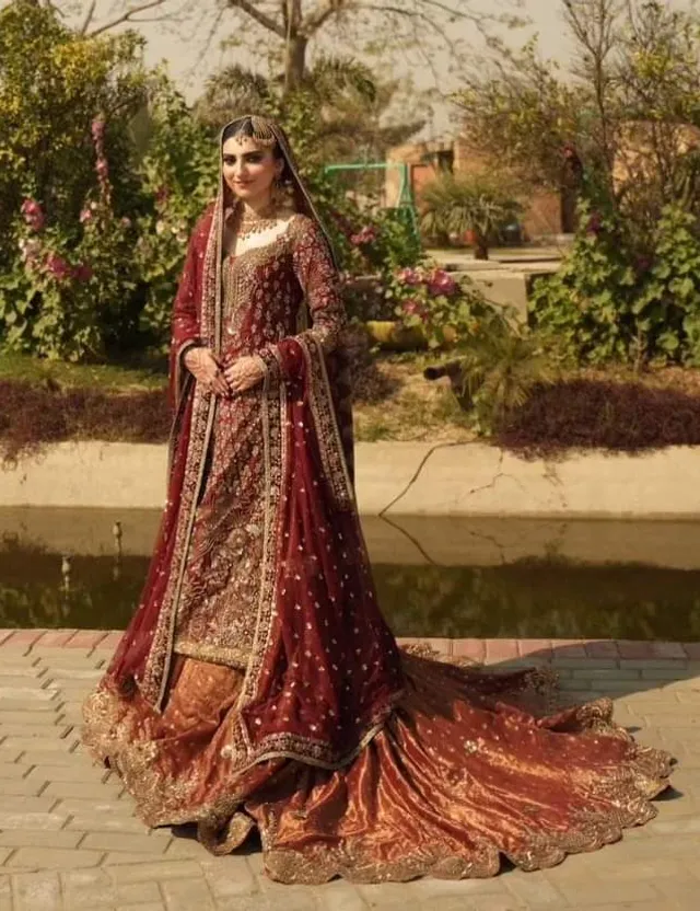 a woman in a red and gold bridal gown