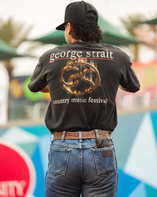 a man wearing a black shirt with a snake on it