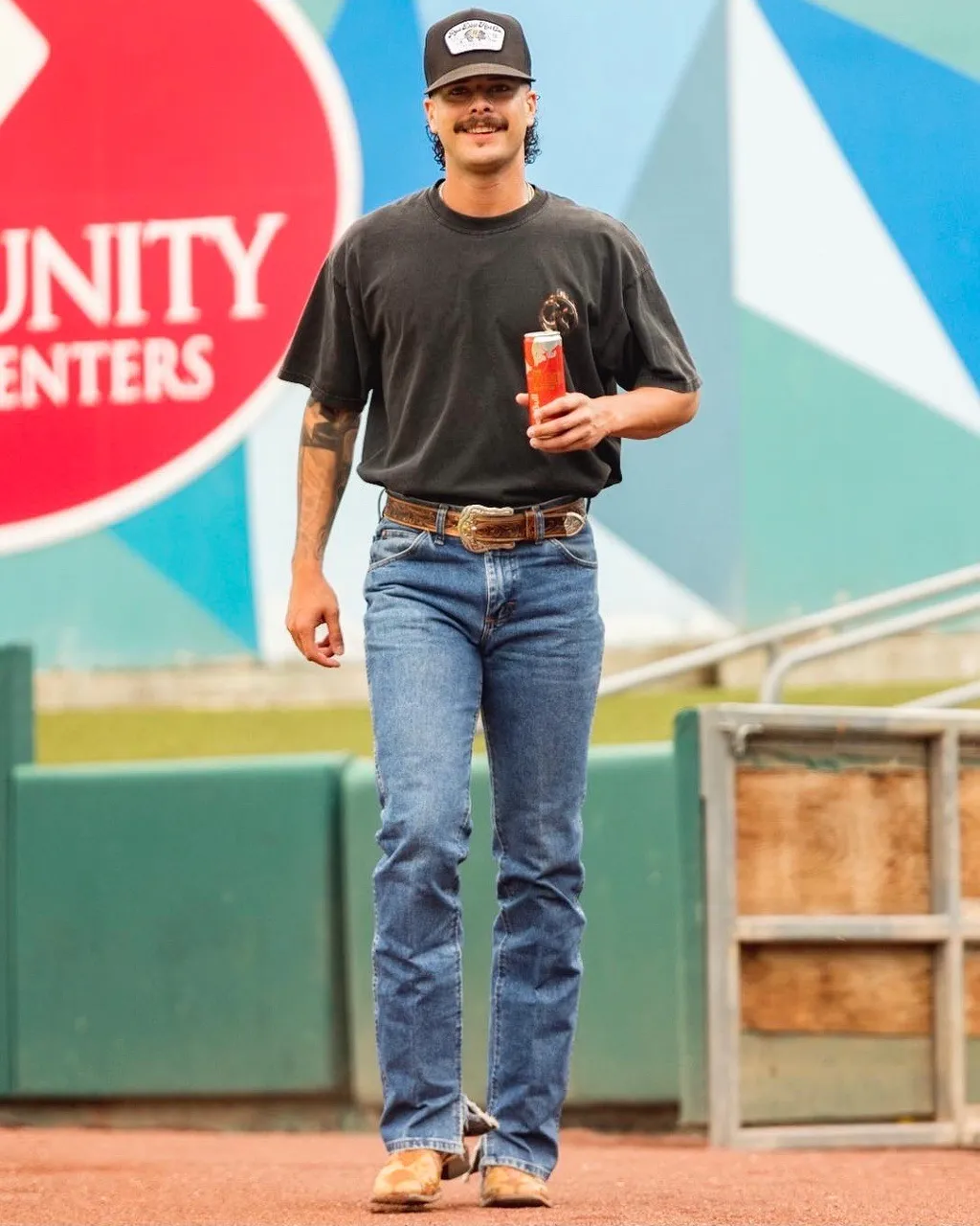 a baseball man in black shirt and jeans