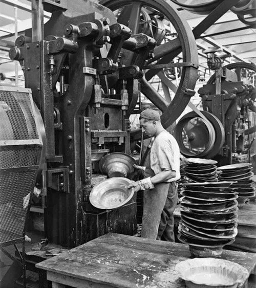 a man working on a machine in a factory