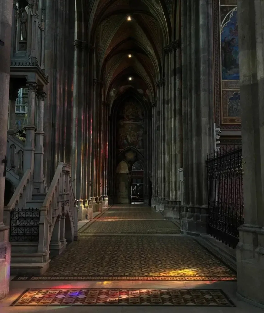 a large cathedral with stained glass windows and a stone floor