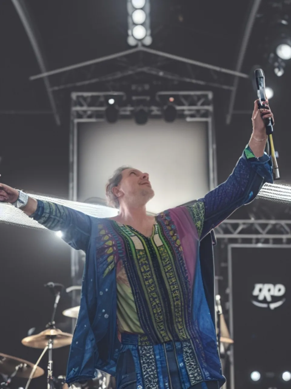 a man standing on a stage holding a microphone