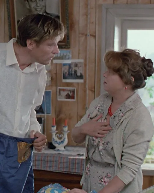 a man standing next to a woman in a kitchen