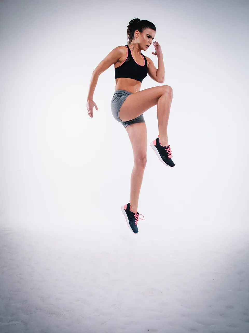 a woman jumping in the air with her leg up