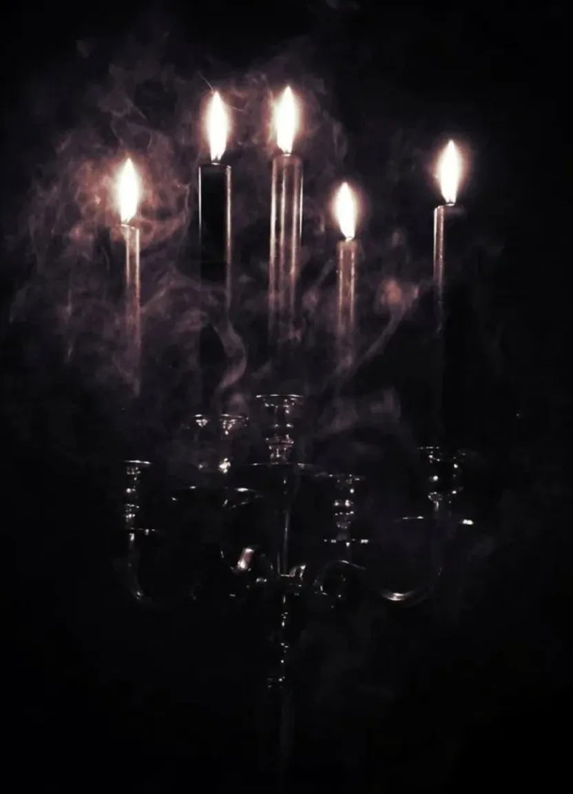 a group of candles that are lit up in the dark