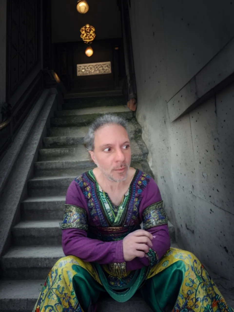 a man sitting on the steps of a building