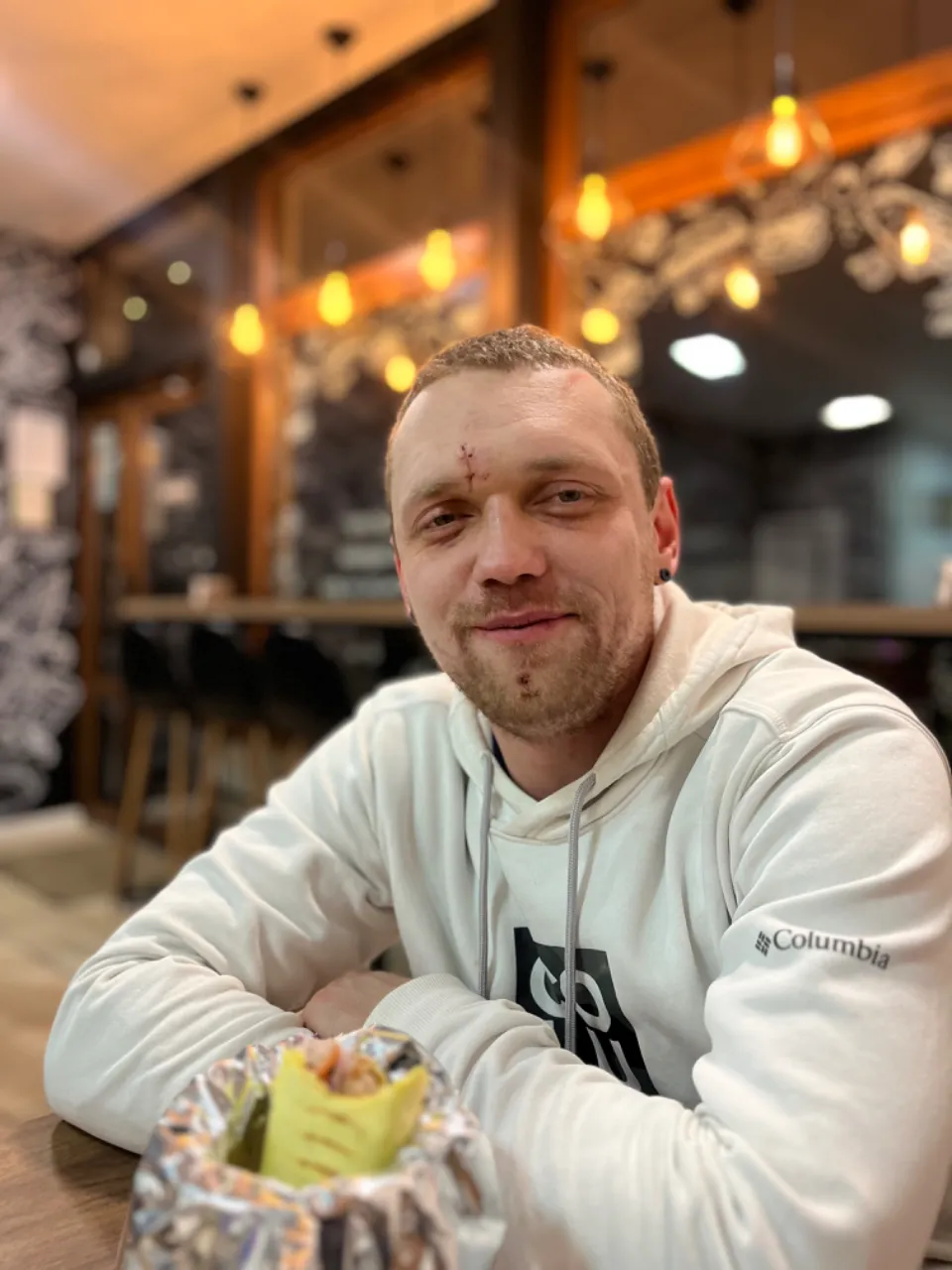 a man sitting at a table in a restaurant